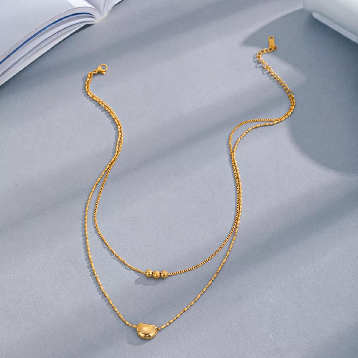 Double layered gold necklace worn on neck - view 2