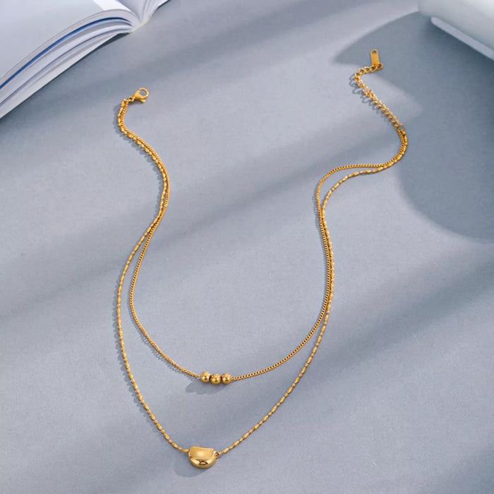 Double layered gold necklace worn on neck - view 2