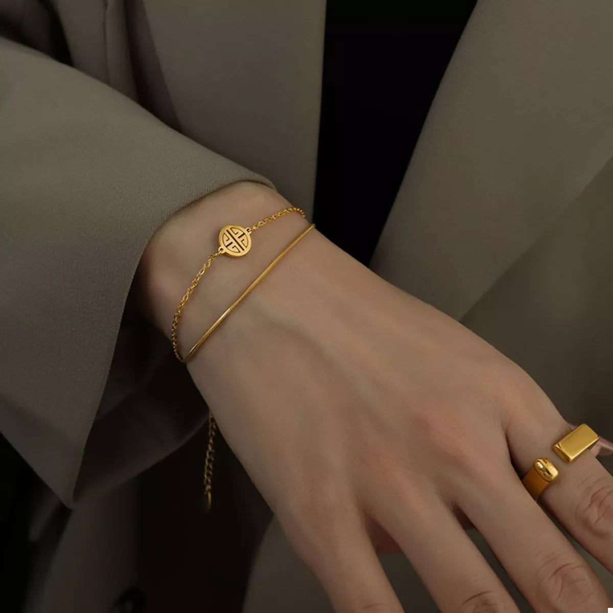 Double layered gold bracelet on wrist - view 2