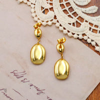 Gold drop earrings worn - view 2