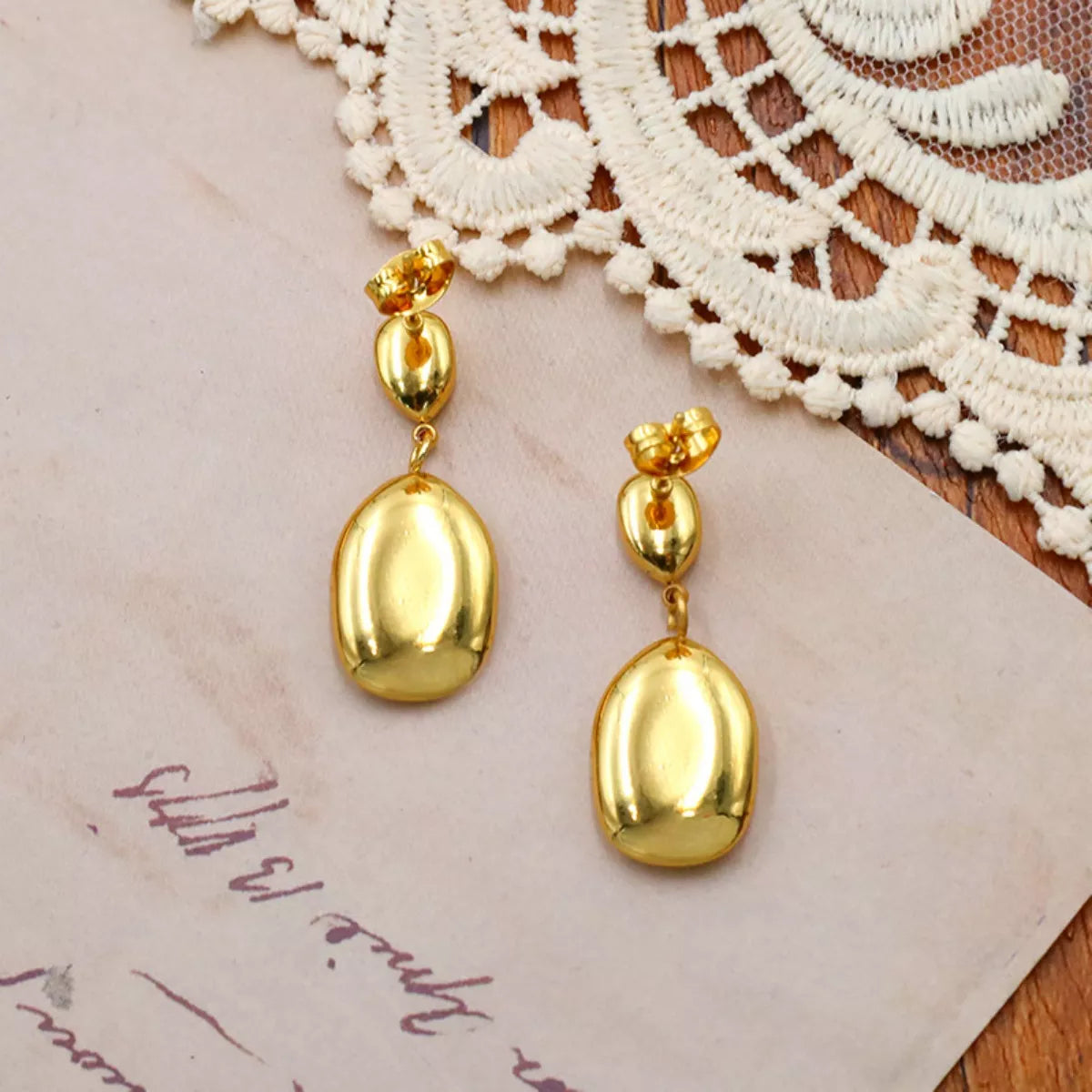 Gold drop earrings worn - view 2
