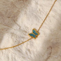 Gold butterfly bracelet on wrist - view 2